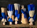 Colorful handmade dolls on a wood