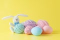 Colorful handmade easter eggs with wool clew and toy rabbit