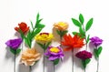 Colorful handmade flowers on a white background with copy space.