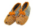 Colorful handmade knitted wool slippers stand on a white background