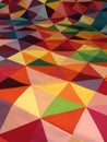 Colorful handmade quilt of many brightly colored fabrics