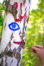 Colorful handprints on a birch tree