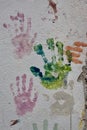 Colorful handprints on a cement wall Royalty Free Stock Photo