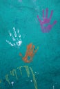 Colorful handprints on a cement wall Royalty Free Stock Photo