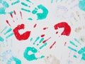 Colorful handprints on a white surface