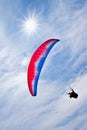 Colorful hang glider in sky