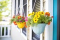 colorful hanging baskets on a front porch