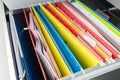 Colorful hanging file folders placed in drawer.