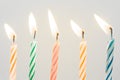 Colorful happy birthday candles close-up with a pastel background