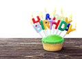 Colorful happy birthday cupcake with candles Royalty Free Stock Photo