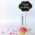 Colorful happy birthday cupcakes with candles with compliments. Birthday cupcake and black board with chalk inscription Royalty Free Stock Photo