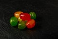 Colorful Hard Candies Pile on Black Texture Background