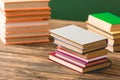 Hardcover books on wooden surface isolated on green Royalty Free Stock Photo