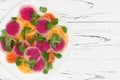 Colorful and healthy carpaccio salad with watermelon radish, tomato and corn salad. Top view, free text copy space