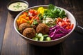 a colorful, healthy falafel salad bowl