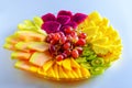 Fruits.Red pitaya dragon fruit, pineapple, grapes, mango, melon, different tropical fruits on plate on white table. Royalty Free Stock Photo