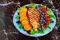 Colorful salad with grilled chicken breast, vegetables and fruits Royalty Free Stock Photo