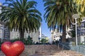 a colorful heart shaped sculpture from the Hearts of San Francisco art exhibit surrounded by lush green trees and plants Royalty Free Stock Photo