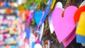 Colorful hearts hanging on wall on the street. Love pink heart shape on blur bokeh background. Copy space Royalty Free Stock Photo