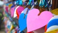 Colorful hearts hanging on wall on the street. Love pink heart shape on blur bokeh background. Copy space Royalty Free Stock Photo