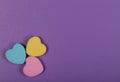 Colorful Hearts. Three Sweetheart Candy over purple background Royalty Free Stock Photo