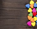 Colorful hearts on wooden background.