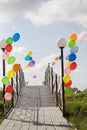 Colorful helium baloons at bridge opposite blue sky Royalty Free Stock Photo