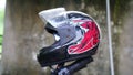 Colorful helmet mounted on a motorcycle handle. Old helmet with blurred background Royalty Free Stock Photo