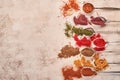 Colorful herbs and spices for cooking: turmeric, dill, paprika, cinnamon, saffron, basil and rosemary. Indian spices. On light