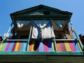 Colorful heritage building with wooden ornamental balcony in Sololaki quarter, Tbilisi, Georgia.