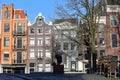 Colorful heritage buildings with gable rooftops, located along Singel Canal, with the statue of Dutch writer Multatuli