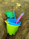 Colorful ÃÂhildren`s toys in the sandbox. Plastic tools: shovel and pail
