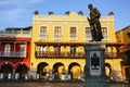 Colorful historic buildings at Plaza de los Cochem on a sunny day in Cartagena with statue in the shadow, Royalty Free Stock Photo