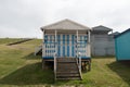 Colorful holiday beach hut holiday homes against blue cloudy sky