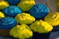 Colorful blue and yellow homemade cupcakes with sprinkles, minion concept party, desserts in blue and yellow color on a table