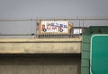 A colorful homemade sign on a freeway overpass in opposition to Donald Trump in the 2020 election.