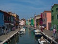 Colorful homes line the canal in Burano Italy