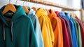 Colorful hoodies and sweatshirts hang on hangers in a clothing store, inviting warmth and style. Ai Generated