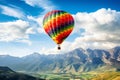 Colorful hot air balloon floating in the sky above the mountains, background Royalty Free Stock Photo