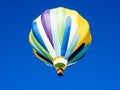 Colorful hot air balloon flying in the bright blue sky Royalty Free Stock Photo