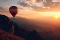 Colorful hot air balloon flying early in the morning over the mountain. Scenic sunrise or sunset view Royalty Free Stock Photo