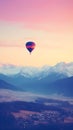 Colorful hot air balloon flying early in the morning over the mountain. Scenic sunrise or sunset view Royalty Free Stock Photo