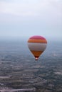 Colorful Hot Air Balloon Flying In Foggy Sky Above Fields