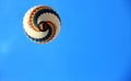 A colorful hot air balloon flying in the large blue sky. Royalty Free Stock Photo