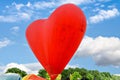 Colorful hot air balloon flying over a blue sky with white clouds Royalty Free Stock Photo