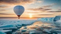 colorful hot air balloon flying over an expanse of snow, water and ice at sunset Royalty Free Stock Photo