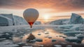 colorful hot air balloon flying over an expanse of snow, water and ice at sunset Royalty Free Stock Photo