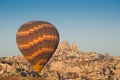 Colorful hot air balloon flying over the Goreme city in Cappadocia Royalty Free Stock Photo