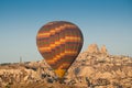 Colorful hot air balloon flying over the Goreme city in Cappadocia Royalty Free Stock Photo