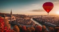 colorful hot air balloon flying over a medieval city with towers and churches at sunset - Royalty Free Stock Photo